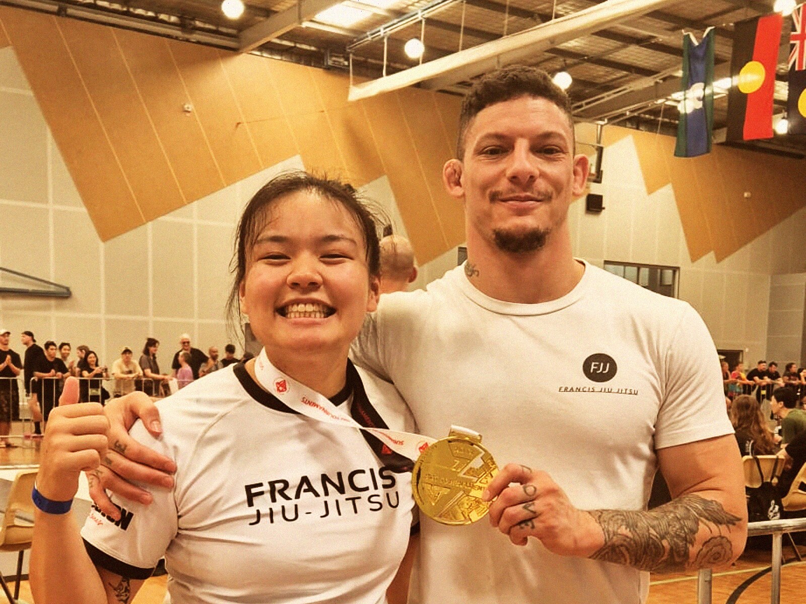 Coach Daan with FJJ student holding gold medal