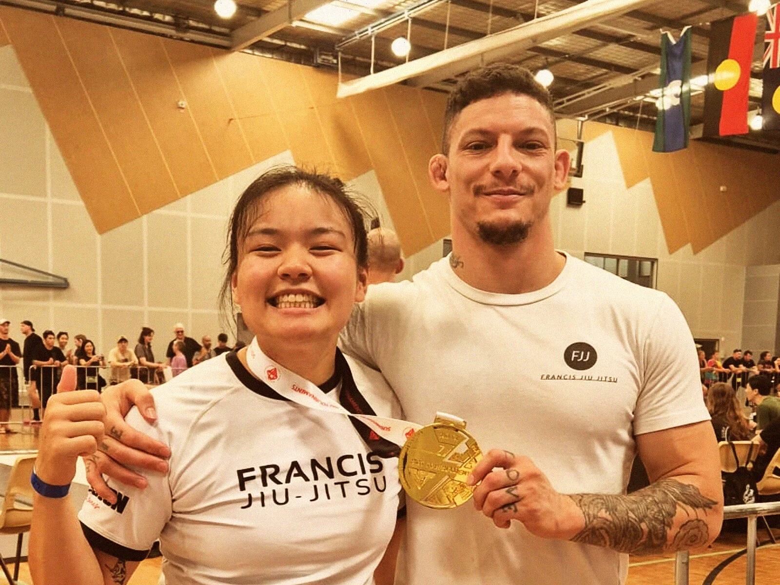 Coach Daan with FJJ student holding gold medal